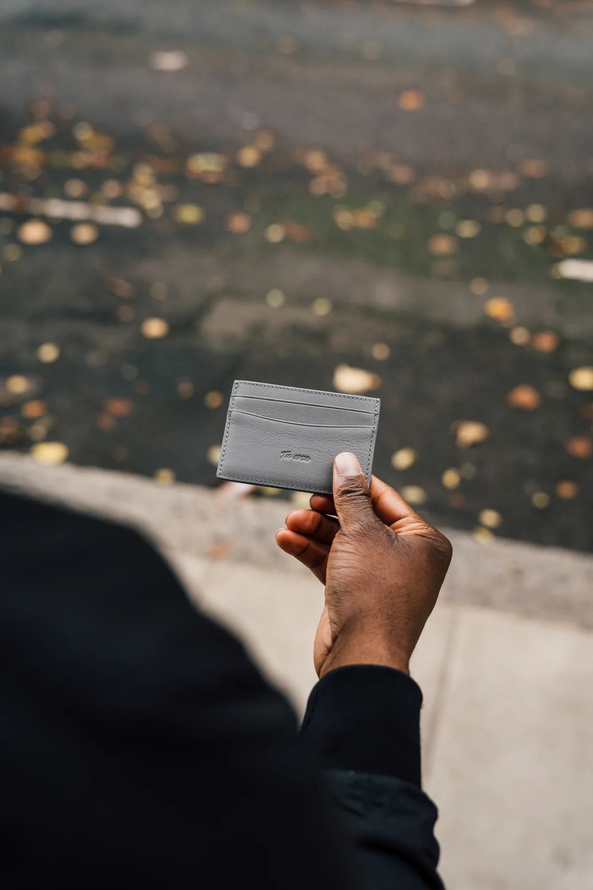 Person holding LNS Tuwon luxury leather wallet, minimalist design for professionals and creatives on their daily journey