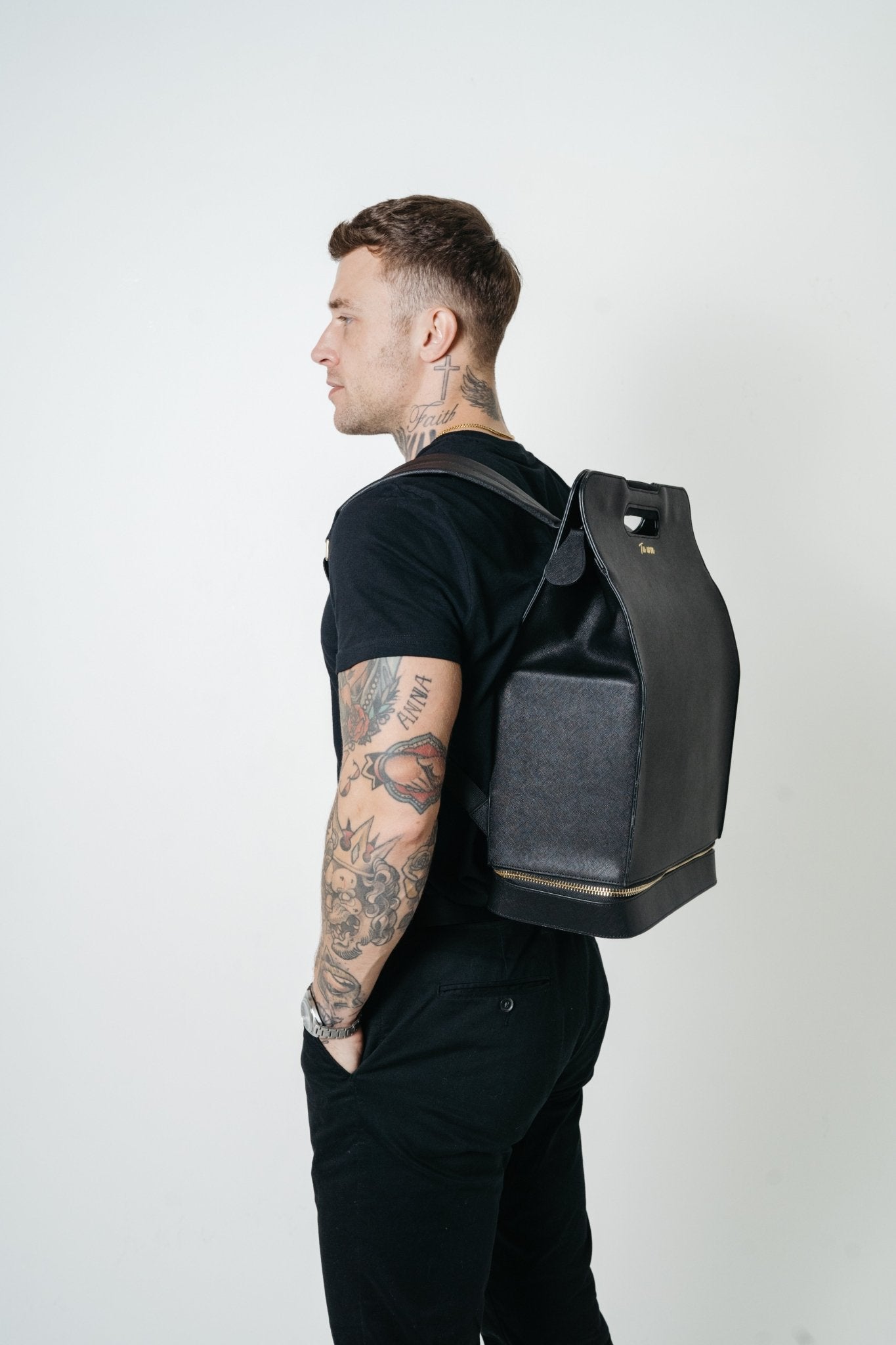 Professional wearing Tuwon luxury black leather backpack in city setting, designed for modern entrepreneurs and creatives