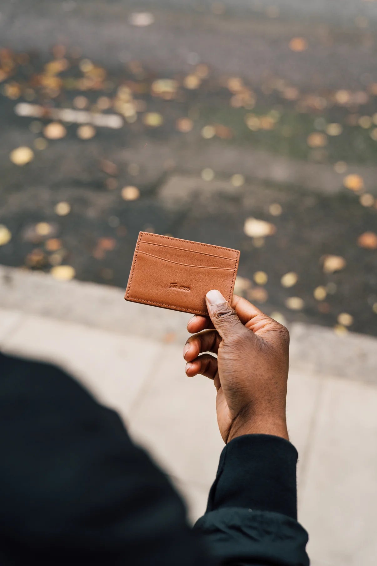 Person holding LNS Tuwon luxury leather wallet, minimalist design for professionals and creatives on their daily journey